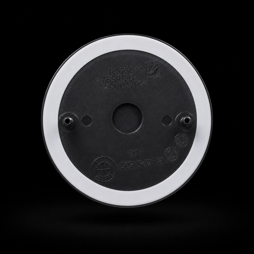 Badge rear view — two mounting pins and double-sided automotive tape ring, no drilling