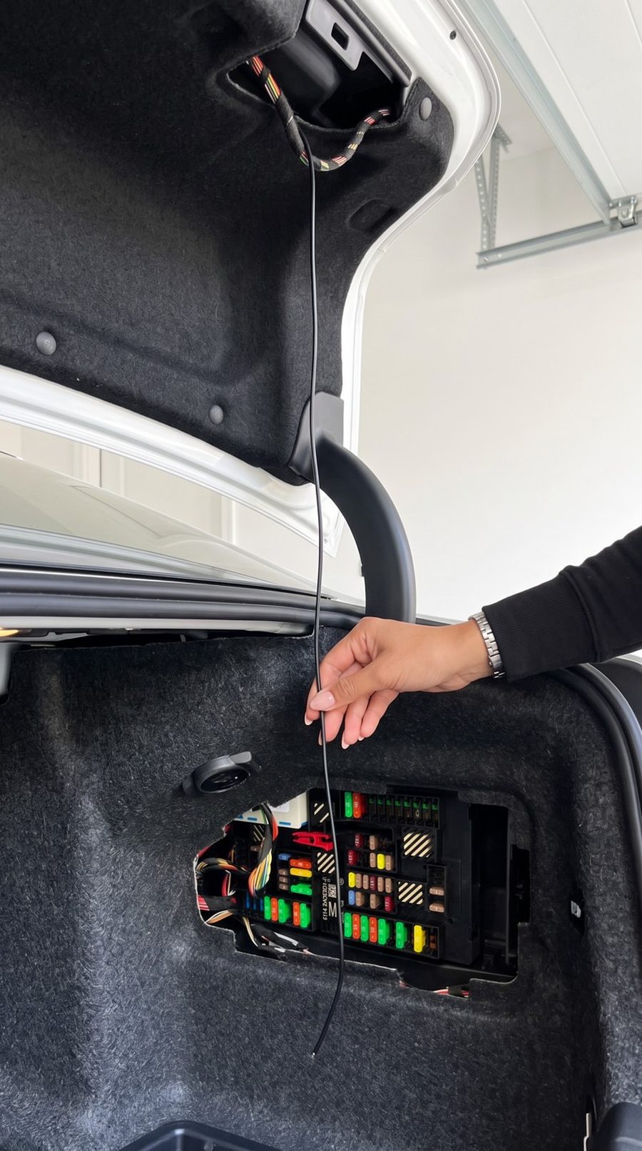 Routing the HALO cable through the factory pin hole into the trunk