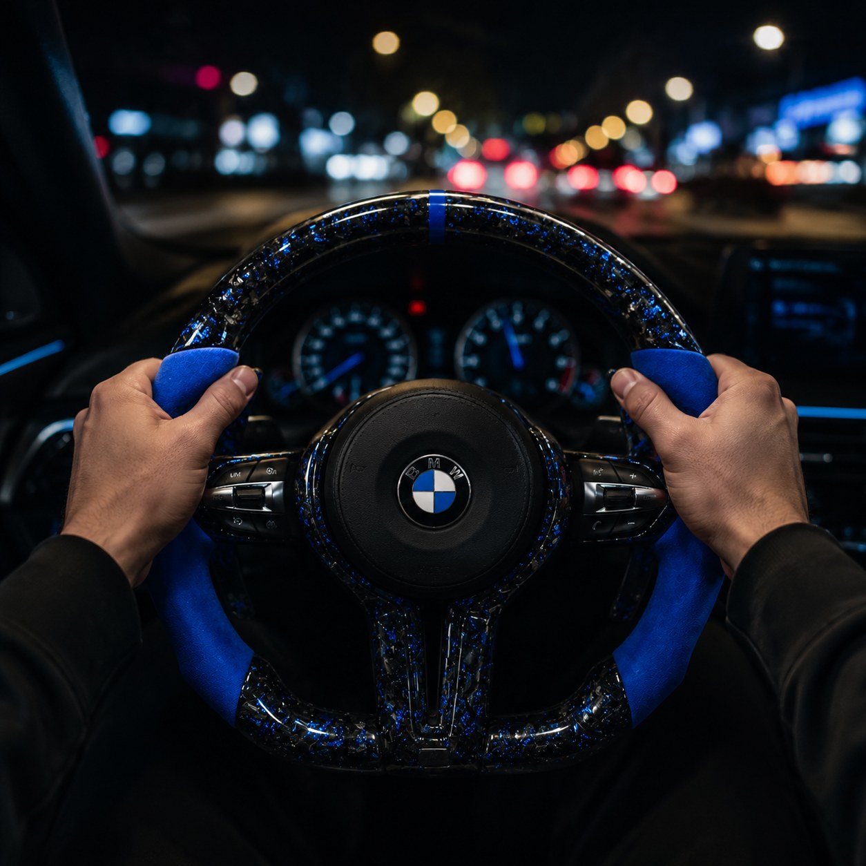 Hands on a REVMODE steering wheel at night